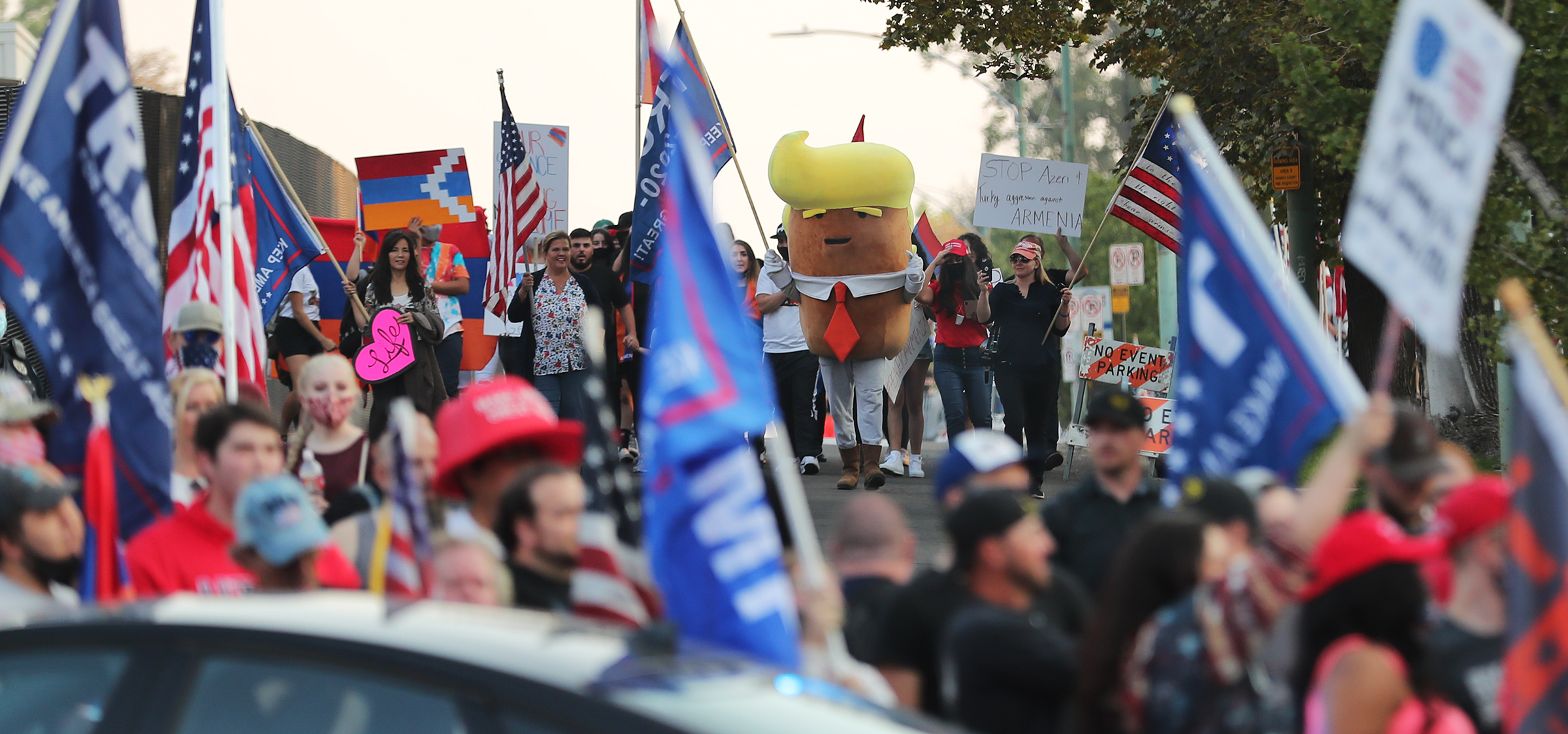 Trump Tater and other Trump supporters walk toward Biden supporters at 100 South and University as groups from both sides gather near Presidents Circle at the University of Utah prior to the vice presidential debate between Vice President Mike Pence and California Sen. Kamala Harris on Wednesday, Oct. 7, 2020.
