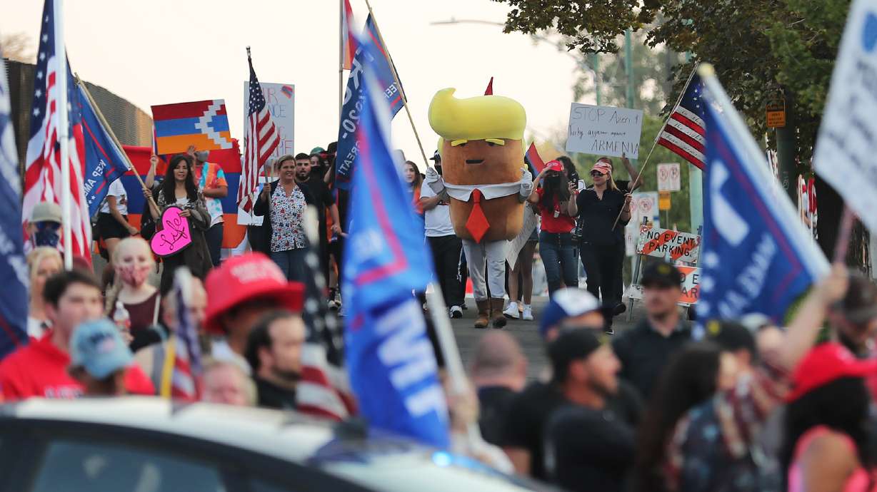 Trump Tater and other Trump supporters walk toward Biden supporters at 100 South and University as groups from both sides gather near Presidents Circle at the University of Utah prior to the vice presidential debate between Vice President Mike Pence and California Sen. Kamala Harris on Wednesday, Oct. 7, 2020.