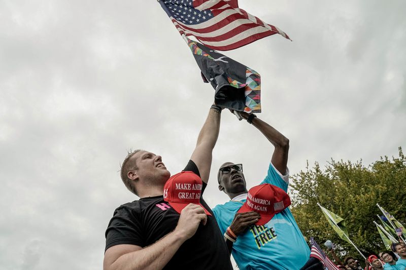 Supporters of U.S. President Donald Trump rally and march on the Ellipse and the streets around the White House after the president's campaign rally on the South Lawn of the White House in Washington, October 10, 2020. REUTERS/Ken Cedeno