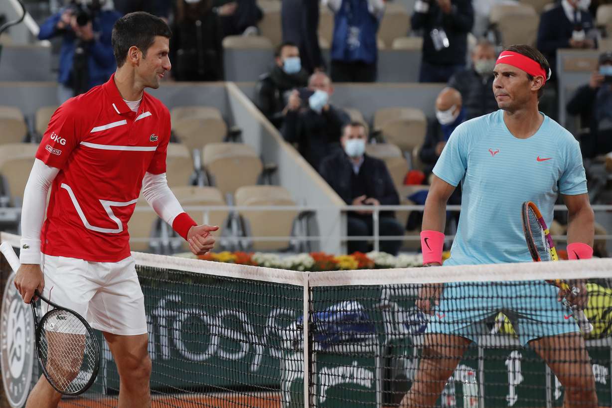 Serbia's Novak Djokovic, left, and Spain's Rafael Nadal look at each other as they pose for images prior to the final match of the French Open tennis tournament at the Roland Garros stadium in Paris, France, Sunday, Oct. 11, 2020.
