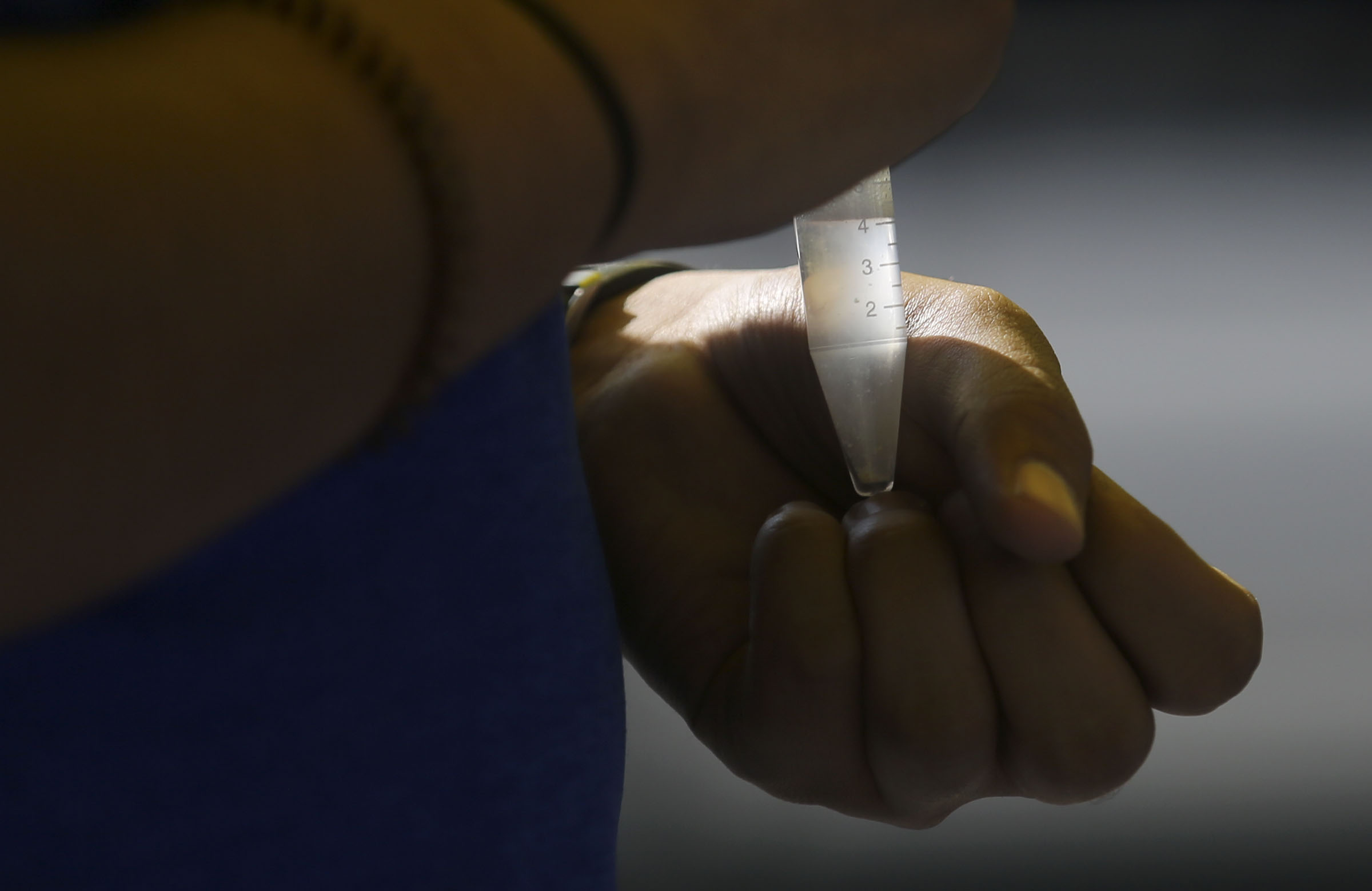 Ricardo Tienda holds his vial of spit as he gets tested for COVID-19 at an Intermountain Healthcare mobile testing site outside of Orem Community Hospital in Orem on Tuesday, Oct. 6, 2020.