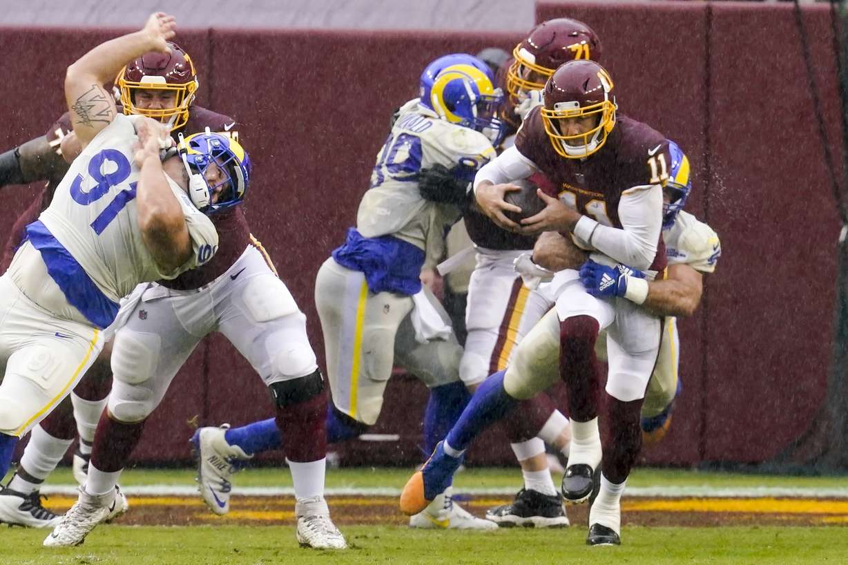 Washington Football Team's Alex Smith is sacked by Los Angeles Rams' Troy Reeder during the second half of an NFL football game Sunday, Oct. 11, 2020, in Landover, Md.
