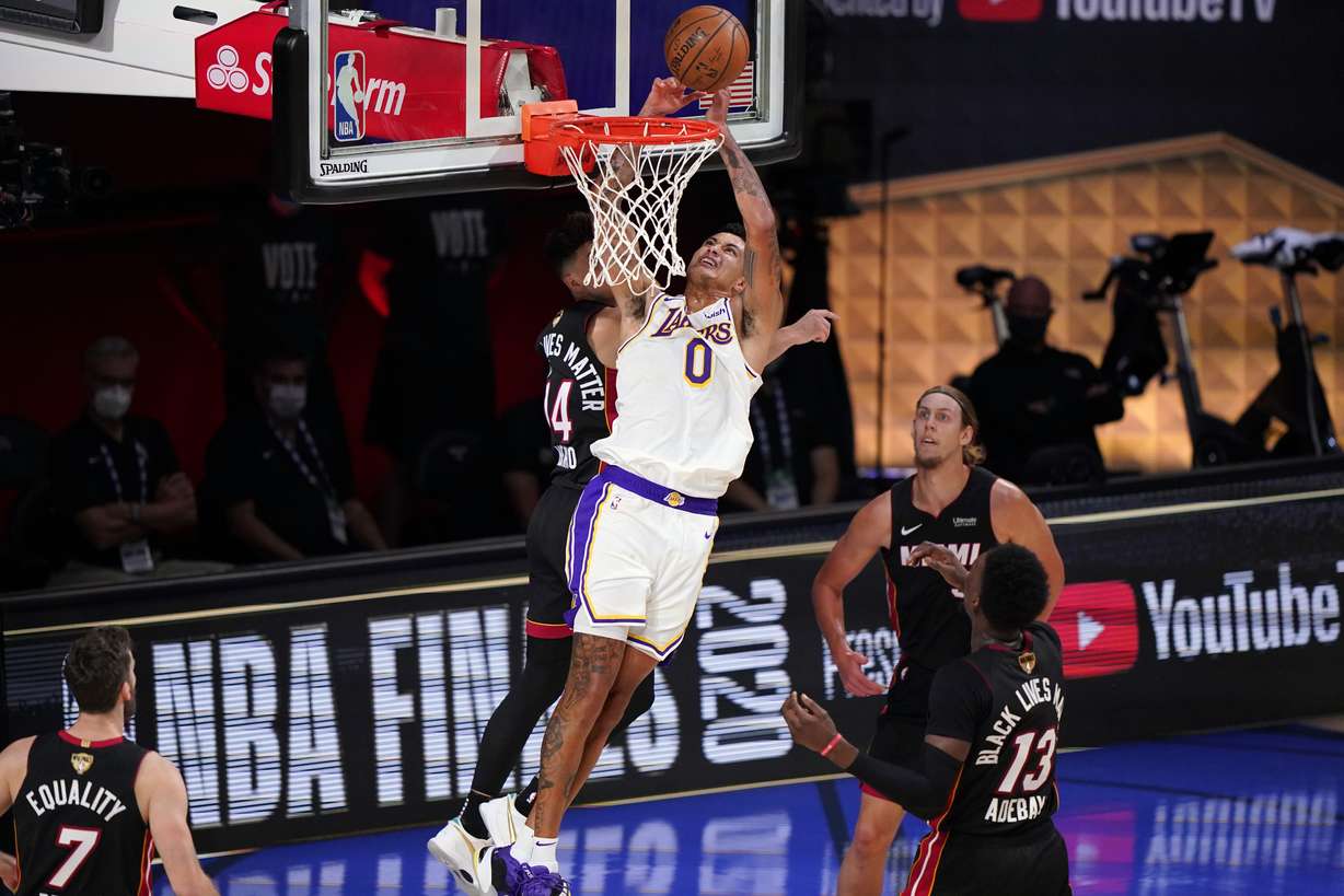 Los Angeles Lakers' Kyle Kuzma (0) takes a shot against Miami Heat's Tyler Herro (14) during the second half in Game 6 of basketball's NBA Finals Sunday, Oct. 11, 2020, in Lake Buena Vista, Fla.