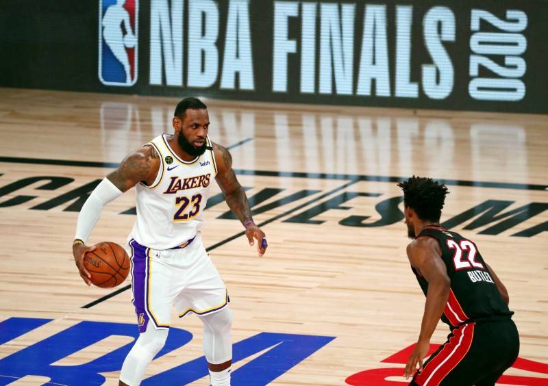 Oct 11, 2020; Lake Buena Vista, Florida, USA; Los Angeles Lakers forward LeBron James (23) dribbles while defended by Miami Heat forward Jimmy Butler (22) during the second quarter in game six of the 2020 NBA Finals at AdventHealth Arena. Kim Klement-USA TODAY Sports