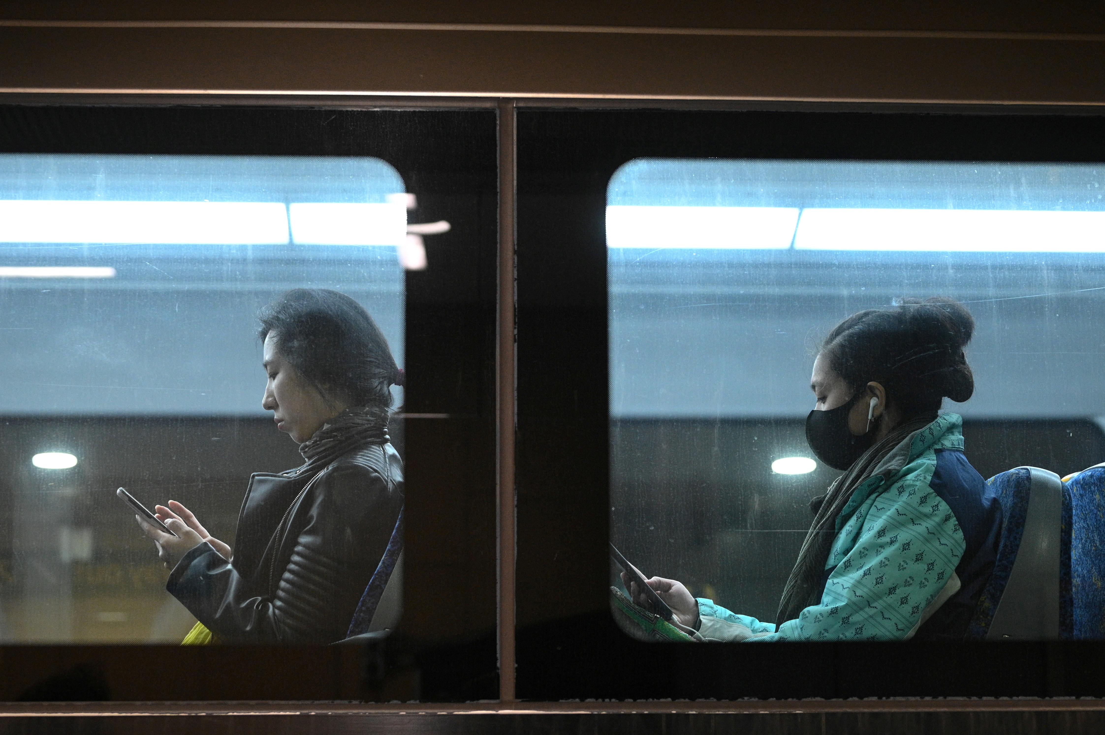 FILE PHOTO: Commuters ride a train in Sydney, Australia, Aug. 19, 2020. REUTERS/Loren Elliott/File Photo