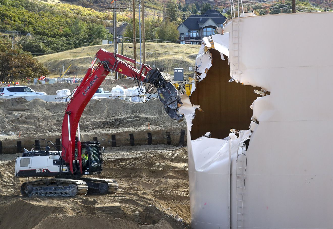 Crews with the Utah Department of Transportation begin dismantling the old water tank near the intersection of Oak Hills Drive and U.S. 89 in Layton on Monday, Oct. 12, 2020.