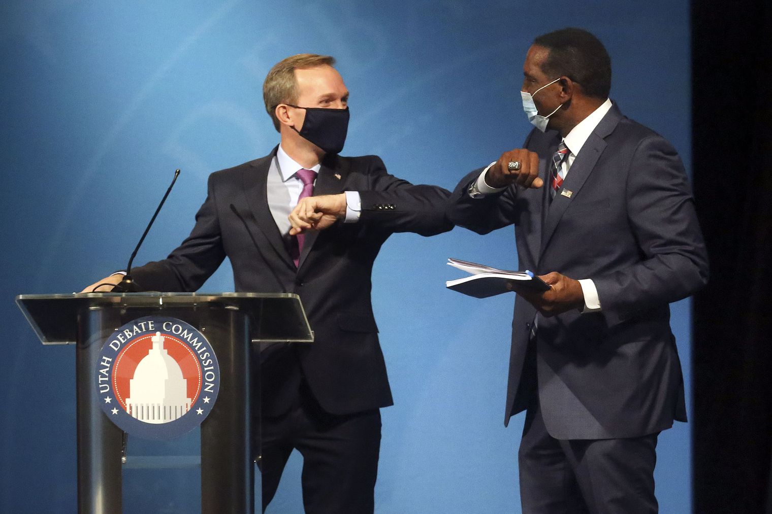 Rep. Ben McAdams, D-Utah, and Burgess Owens bump elbows after participating in the 4th Congressional District debate at the Triad Center in Salt Lake City on Monday, Oct. 12, 2020.