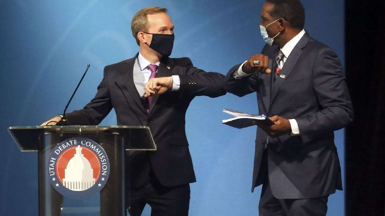 Rep. Ben McAdams, D-Utah, and Burgess Owens bump elbows after participating in the 4th Congressional District debate at the Triad Center in Salt Lake City on Monday, Oct. 12, 2020.