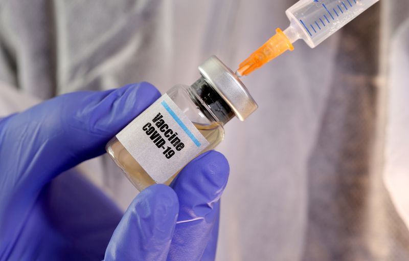 FILE PHOTO: A small bottle labeled with a "Vaccine COVID-19" sticker and a medical syringe in this illustration taken April 10, 2020. REUTERS/Dado Ruvic