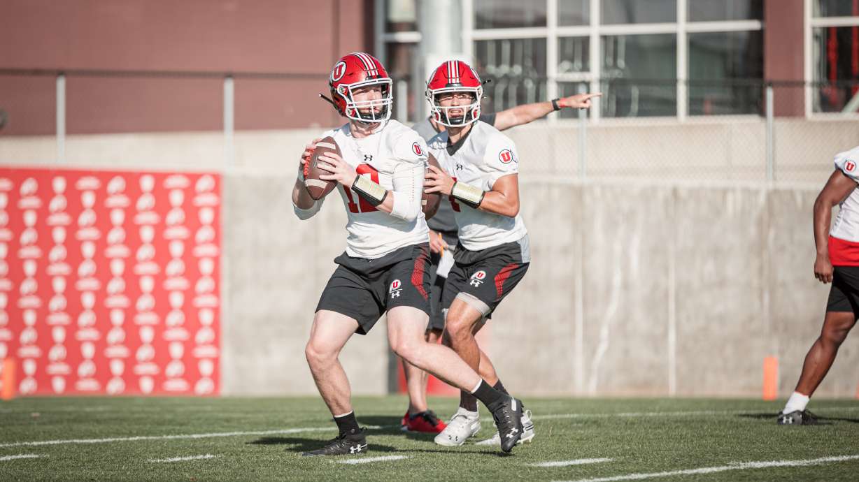 Quarterbacks Cam Rising and Drew Lisk throw passes during the first day of fall camp at the University of Utah.