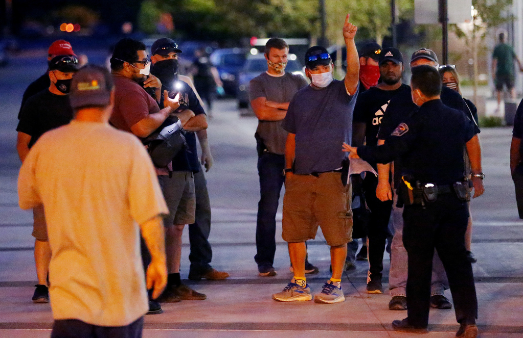 Counterprotesters try to get police to remove a man taking video of them during a demonstration at the West Valley City Police Department on Sept. 16, 2020.