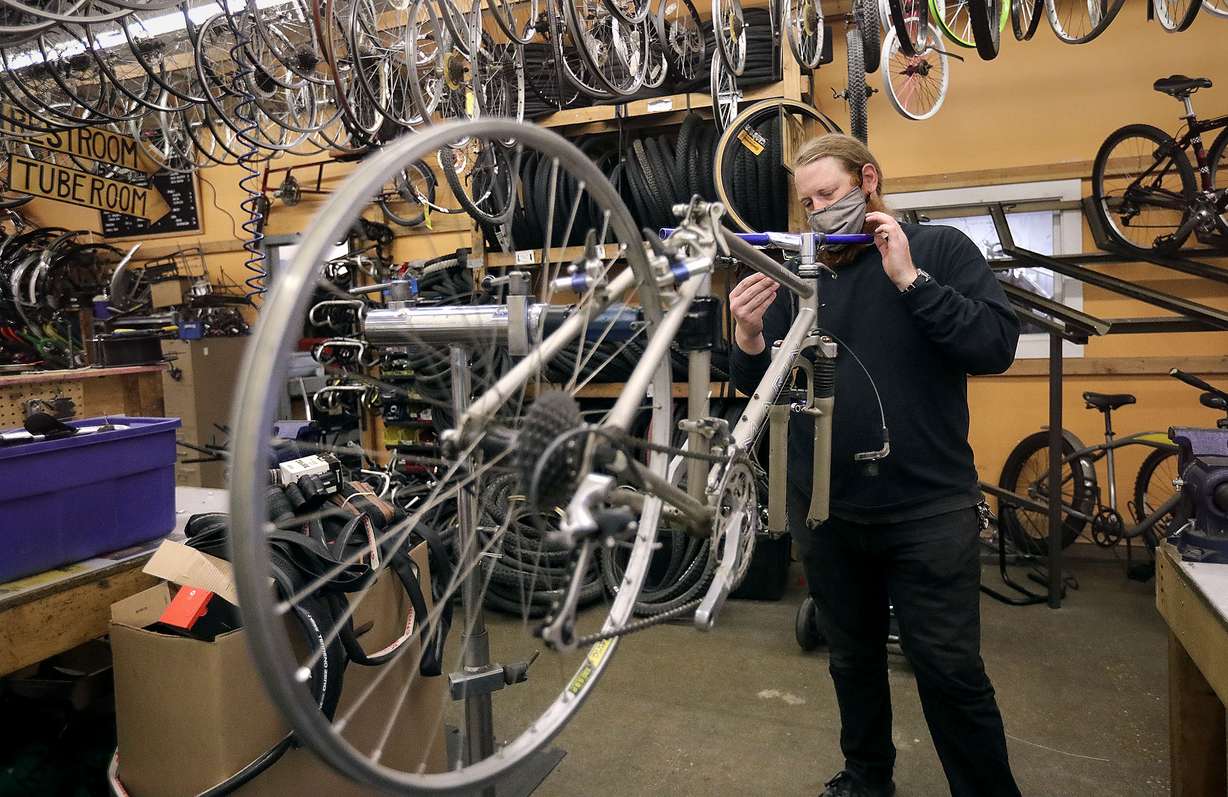Kai Cox, director of the Salt Lake City Bicycle Collective, works on a bike at the Bicycle Collective in Salt Lake City on Wednesday, Oct. 14, 2020. Data shows there has been an increase in walking and biking during the COVID-19 pandemic.