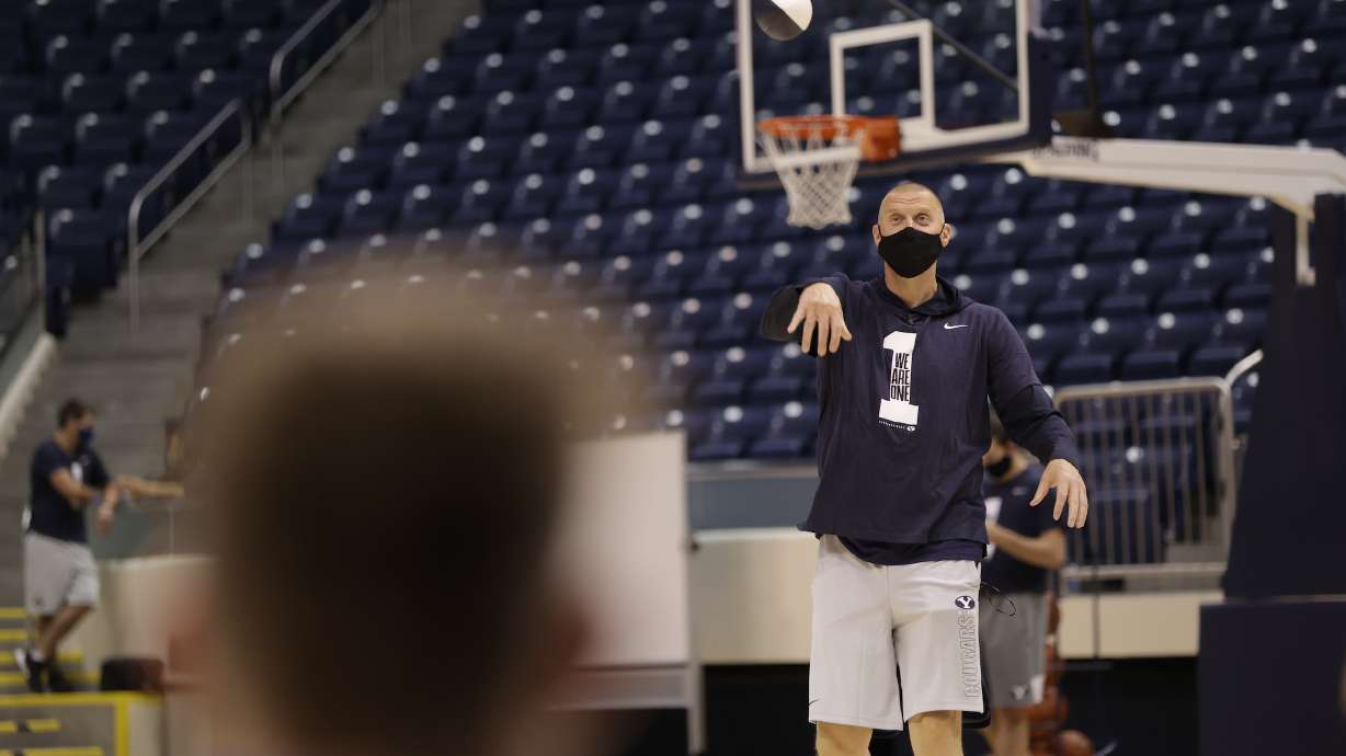 BYU coach Mark Pope throws a football during the first day of practice, Wednesday, Oct. 14, 2020 in the Marriott Center in Provo.