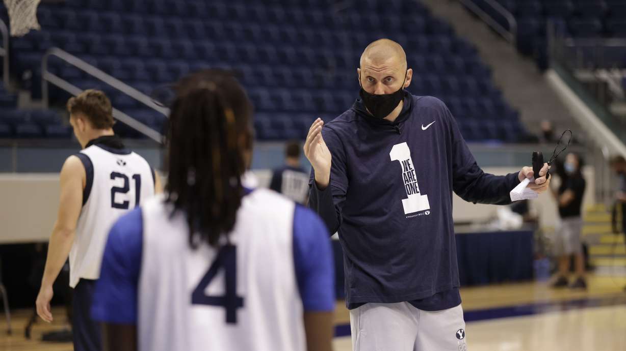 BYU coach Mark Pope talks to point guard Brandon Averette during the first day of practice, Wednesday, Oct. 14, 2020, in the Marriott Center in Provo.