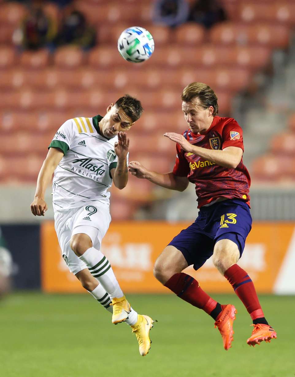 Portland Timbers forward Felipe Mora (9) and Real Salt Lake midfielder Nick Besler (13) go up for the ball as RSL and Portland play an MLS soccer game at Rio Tinto Stadium in Sandy on Wednesday, Oct. 14, 2020.