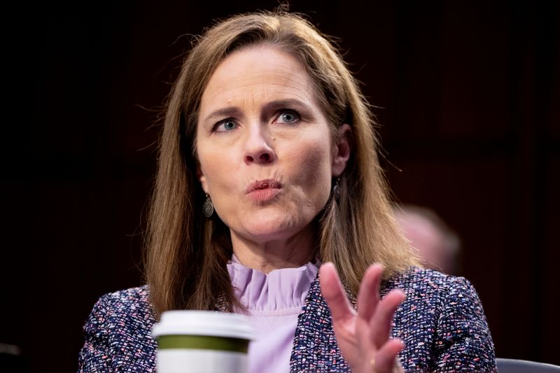 FILE PHOTO: Judge Amy Coney Barrett responds to a question from Democratic vice presidential candidate Senator Kamala Harris (D-CA) during the third day of her Senate confirmation hearing to the Supreme Court on Capitol Hill in Washington, DC, U.S., Oct. 14, 2020. Michael Reynolds/Pool via REUTERS/File Photo