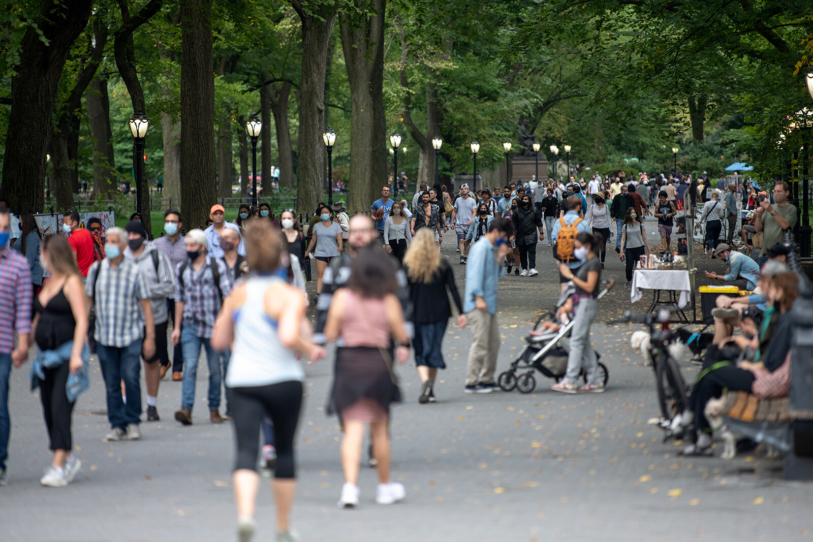 People with and without masks avoid social distancing while walking in Central Park as the city continues Phase 4 of re-opening following restrictions imposed to slow the spread of coronavirus on September 26, 2020 in New York City.