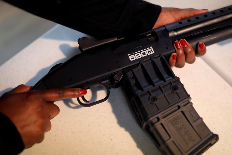Andreyah Garland, a 44-year-old single mother of three daughters and member of the Hudson Valley Nubian Gun Club, picks up her Mossberg 590M 12 gauge shotgun as she prepares for a gun training session in Newburgh, New York, U.S., October 13, 2020. Picture taken October 13, 2020. REUTERS/Mike Segar