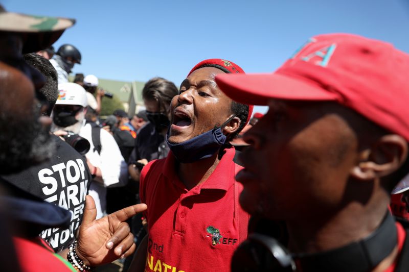 A member of the Economic Freedom Fighters (EFF) shouts outside of the Senekal magistrate's court, where two suspects for the murder of a farm manager, Brendin Horner, are to make a court appearance, in Senekal, in the Free State province, South Africa October 16, 2020. REUTERS/Siphiwe Sibeko
