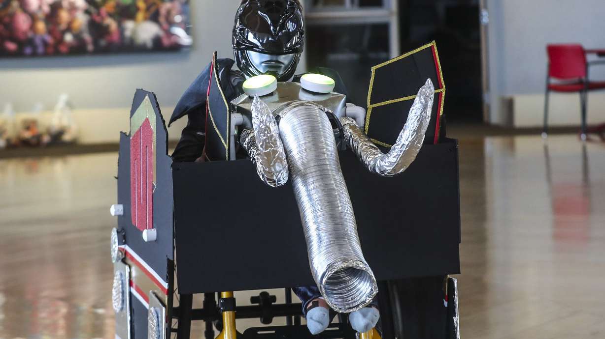 Skylar Skuza zips around in his Power Ranger costume and his decorated wheelchair at Shriners Hospitals for Children in Salt Lake City on Thursday, Oct. 15, 2020. Hospital staff and volunteers transformed his wheelchair during the hospital’s annual wheelchair costume clinic.