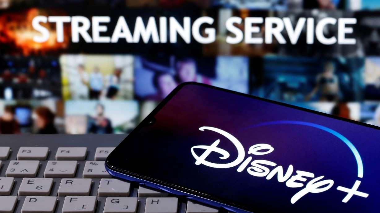 FILE PHOTO: A smartphone with displayed "Disney" logo is seen on the keyboard in front of displayed "Streaming service" words in this illustration taken March 24, 2020. REUTERS/Dado Ruvic