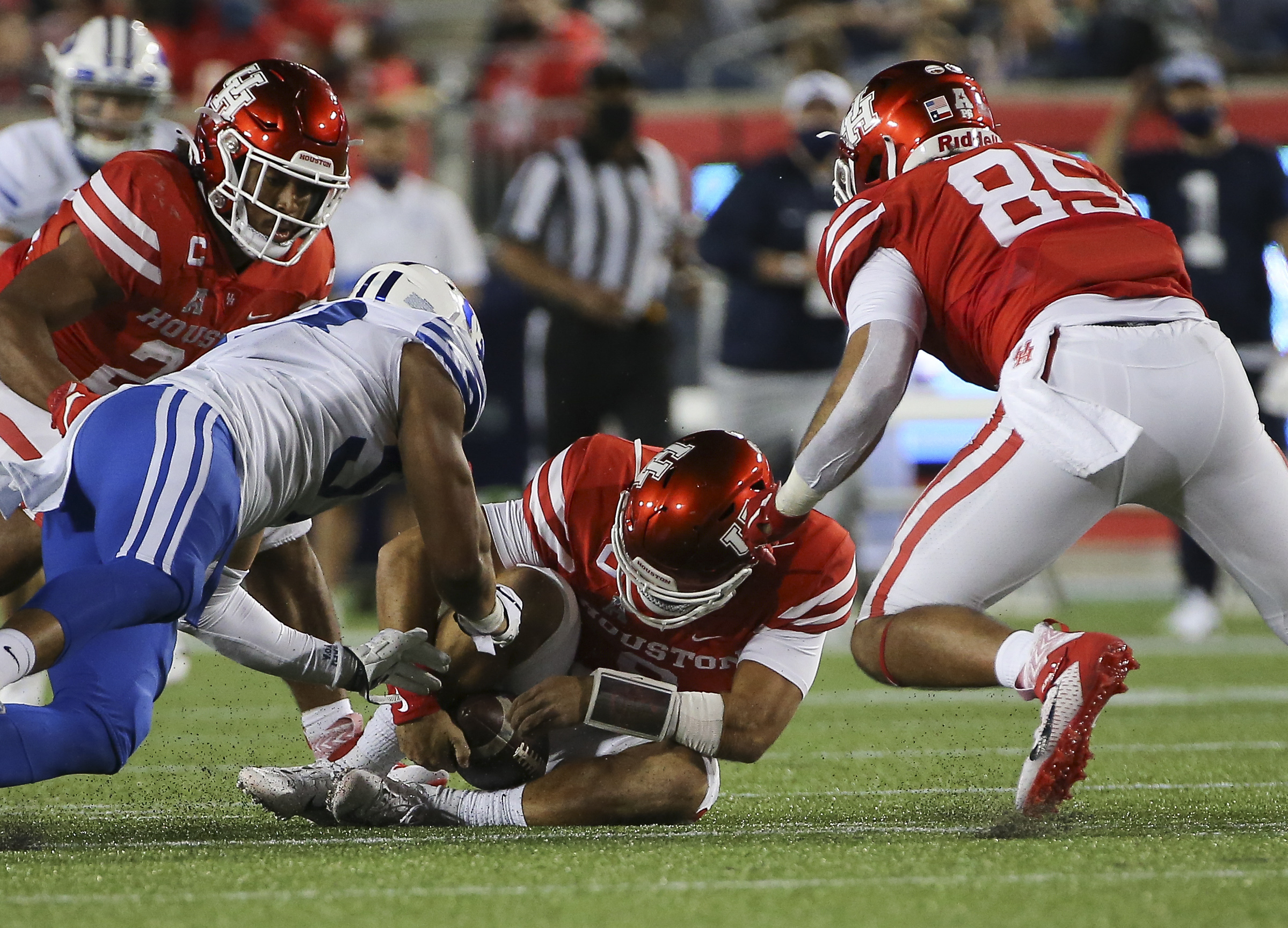 Houston quarterback Clayton Tune (3) fumbles but recovers the ball during the third quarter of an NCAA college football game against BYU Friday, Oct. 16, 2020, in Houston.