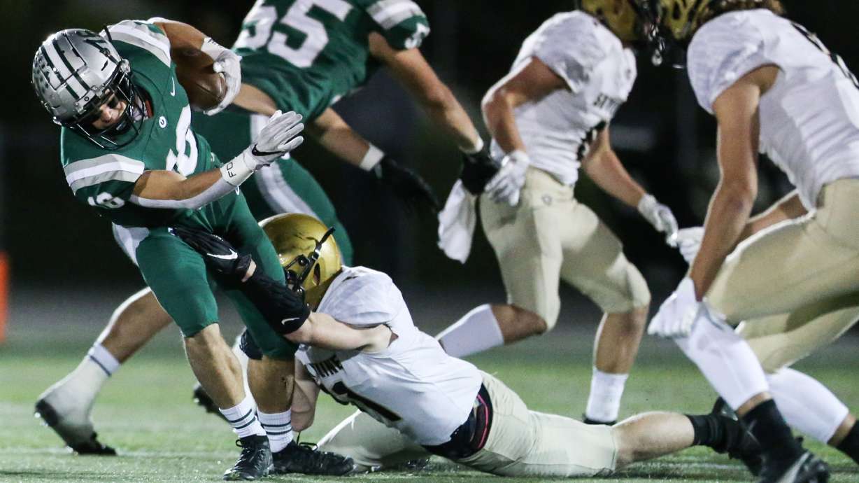Olympusâ Peyton Rice (16) carries the ball against the Skyline defense during a high school football game at Olympus High School in Holladay on Friday, Oct. 16, 2020.