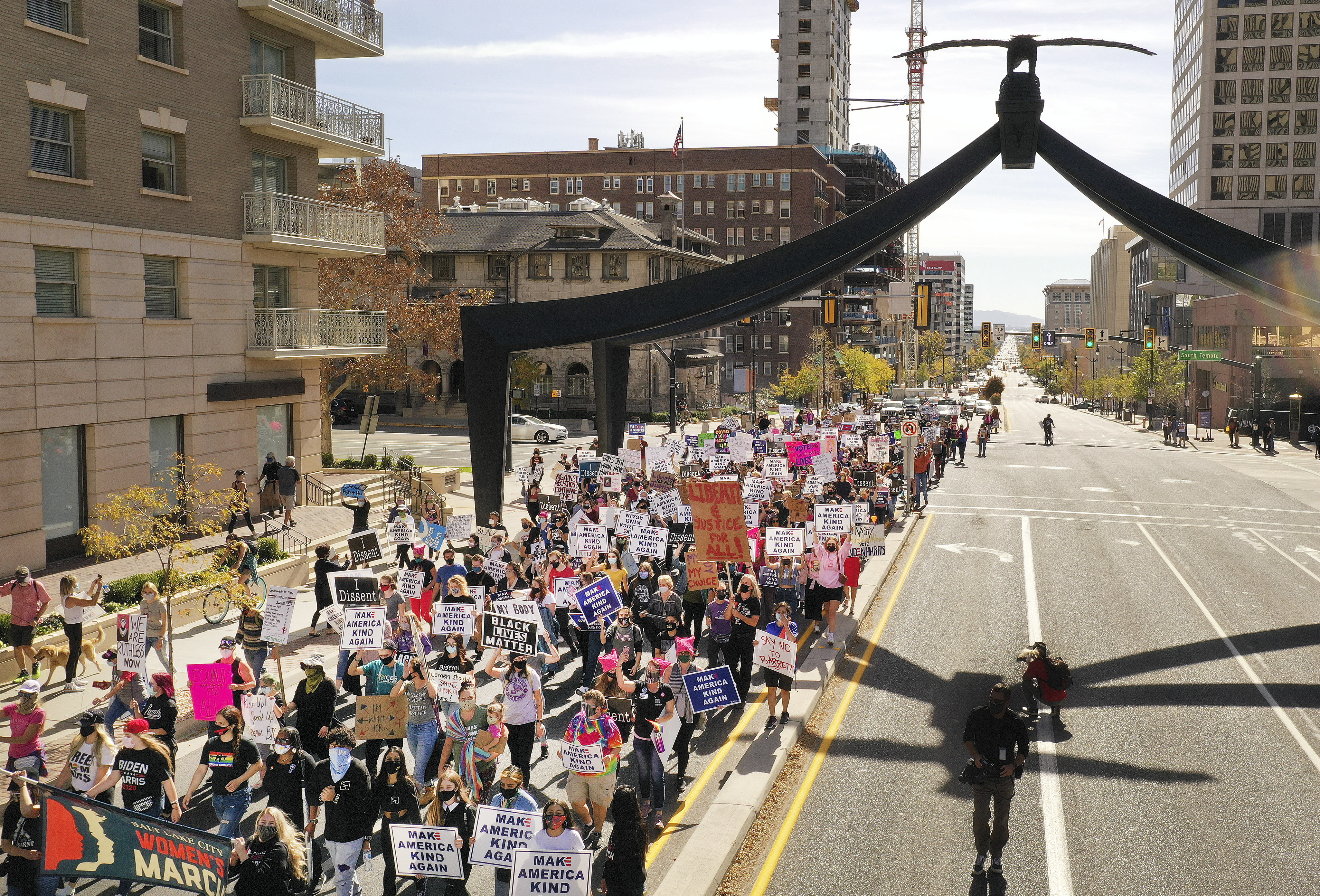 Women's march participants walk on State Street to the state Capitol in Salt Lake City on Saturday, Oct. 17, 2020. The march was tied to a Washington D.C. march in opposition to President Donald Trump.