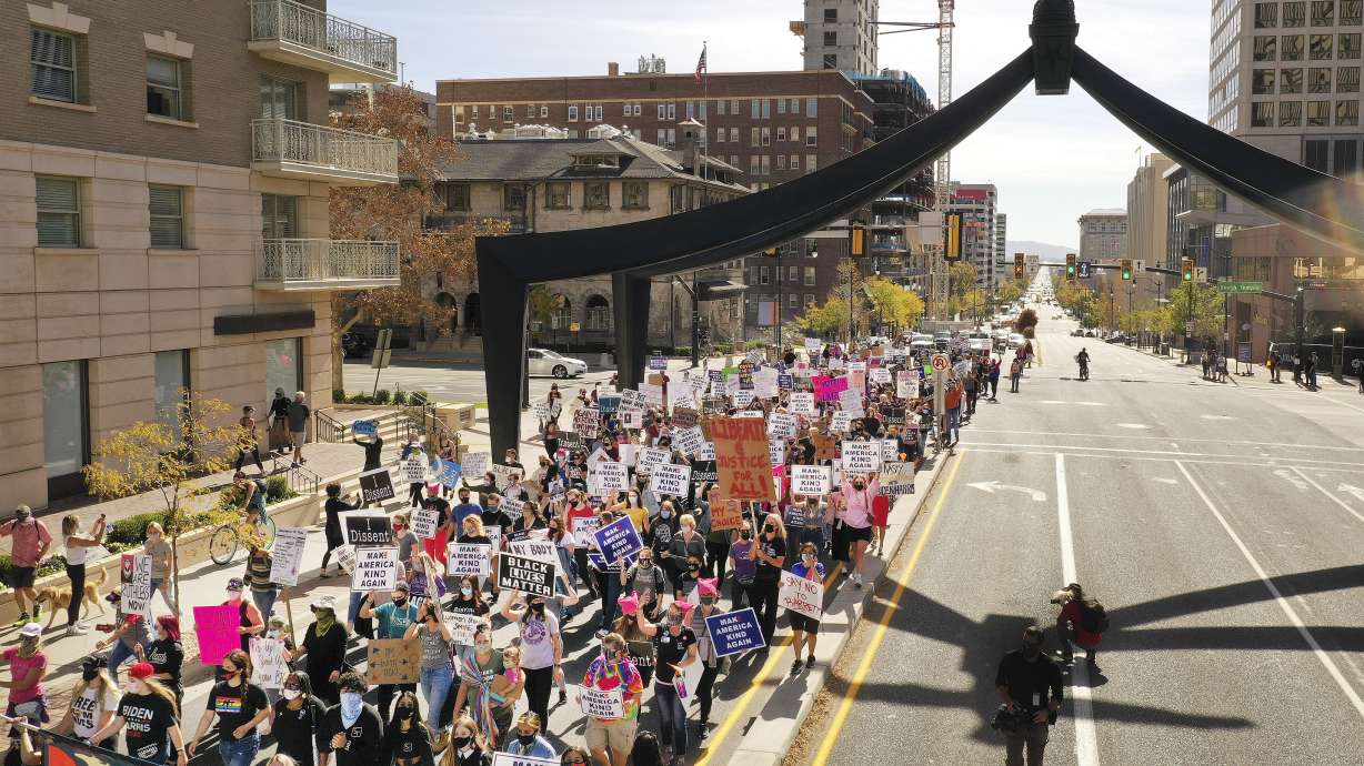 Women's march participants walk on State Street to the state Capitol in Salt Lake City on Saturday, Oct. 17, 2020. The march was tied to a Washington D.C. march in opposition to President Donald Trump.