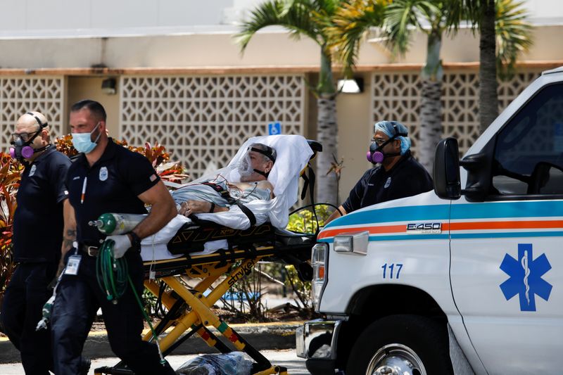 FILE PHOTO: Emergency Medical Technicians (EMT) leave with a patient at Hialeah Hospital where the coronavirus disease (COVID-19) patients are treated, in Hialeah, Florida, U.S., July 29, 2020. REUTERS/Marco Bello