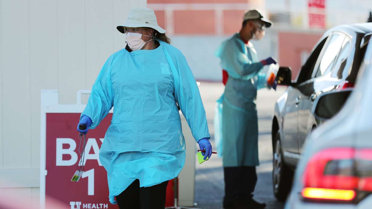 Nurses Polly Crookston and Daniel Salas Jimenez work at a new COVID-19 testing site in the parking lot of Rice-Eccles Stadium in Salt Lake City on Monday, Oct. 12, 2020. The testing site is open Monday through Friday, 8 a.m. to 4 p.m., and Saturday and Sunday, 8 a.m. to noon. Appointments are required.
