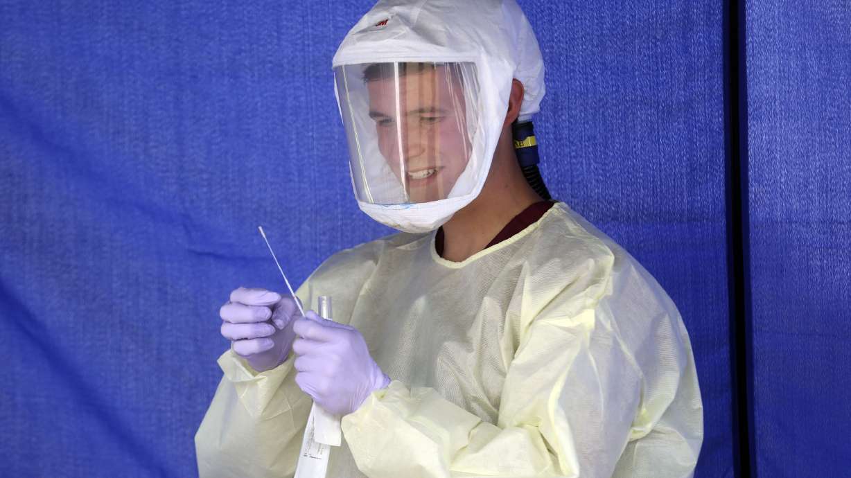Phlebotomist Ethan Laudie performs a COVID-19 test at an Intermountain Healthcare COVID-19 mobile testing site outside of Orem Community Hospital in Orem on Tuesday, Oct. 6, 2020.