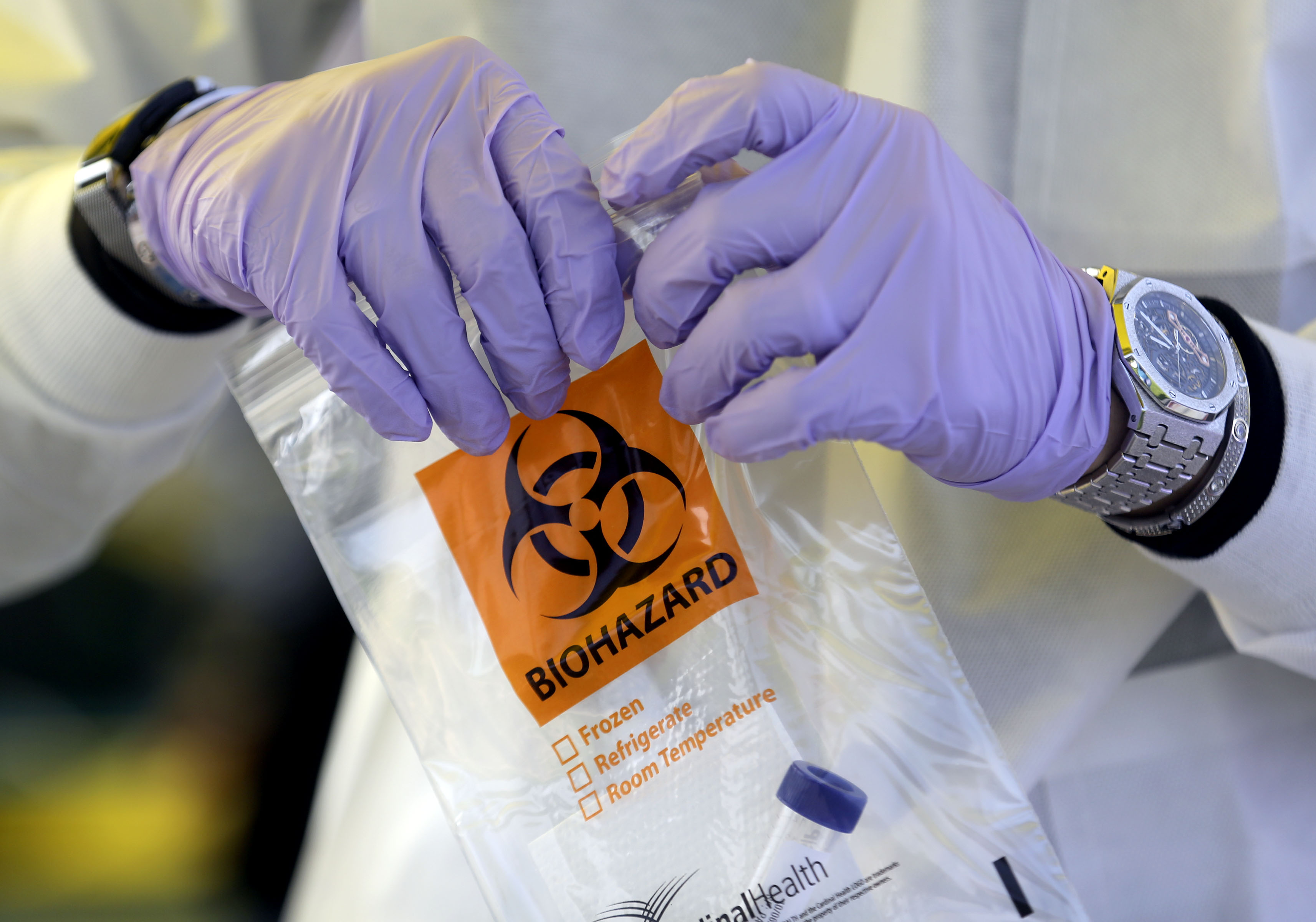 Phlebotomist David Sagae handles a vial of saliva at an Intermountain Healthcare COVID-19 mobile testing site outside of Orem Community Hospital in Orem on Tuesday, Oct. 6, 2020.