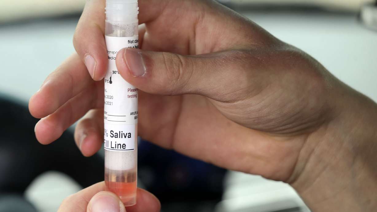 Sven Karabegovic holds his COVID-19 saliva test at a drive-thru test site at University of Utah Health's South Jordan Health Center in South Jordan on Friday, Oct. 2, 2020.