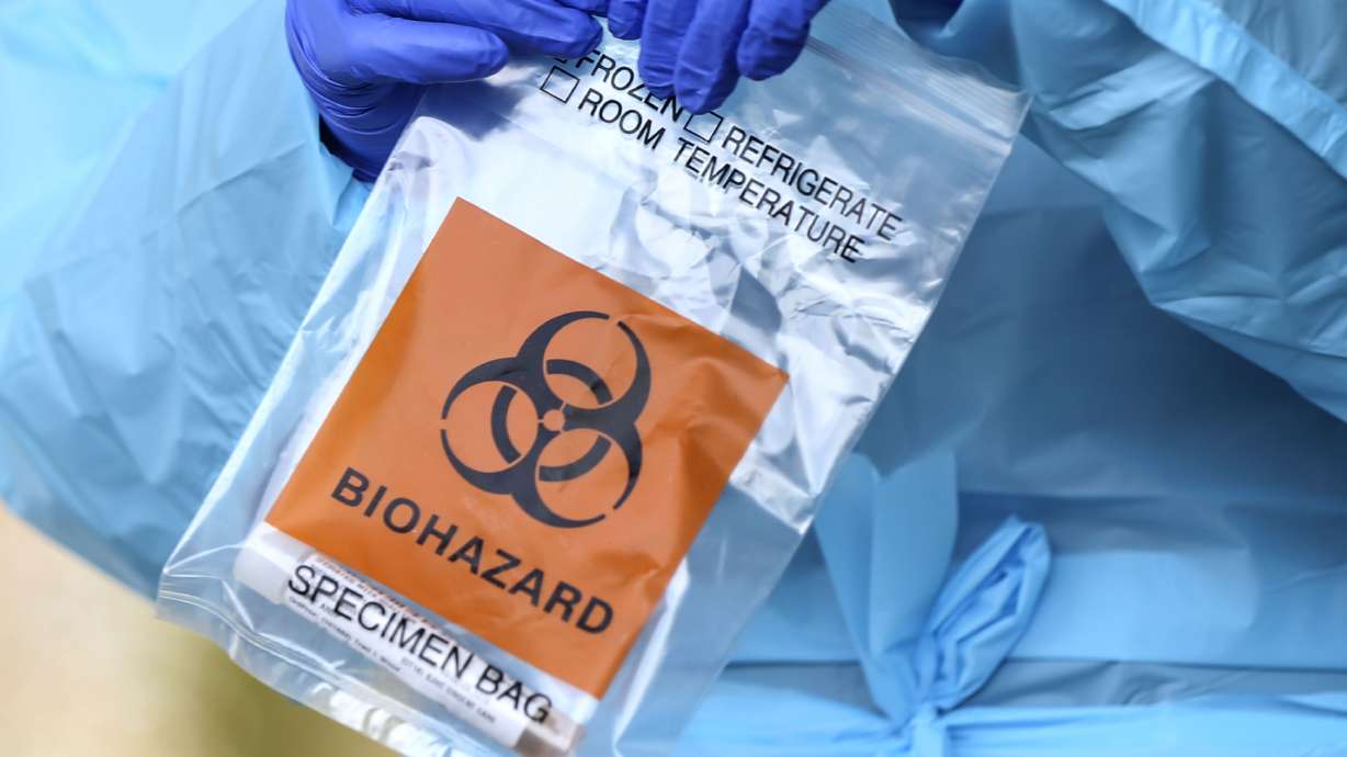 Medical assistant Guillianna Lint holds a COVID-19 test at University of Utah Health's South Jordan Health Center in South Jordan on Friday, Oct. 2, 2020.