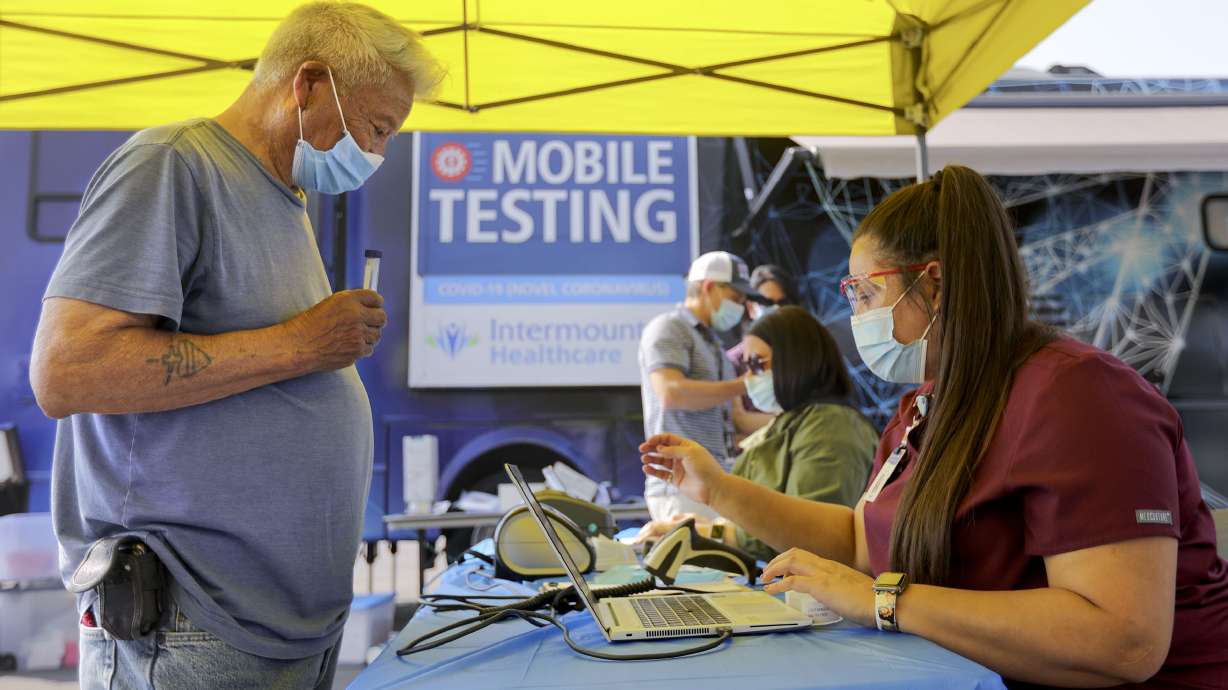 Salvador Castaneda checks in with phlebotomist Crystal Granados during his COVID-19 testing at an Intermountain Healthcare mobile testing site outside of Orem Community Hospital in Orem on Tuesday, Oct. 6, 2020.