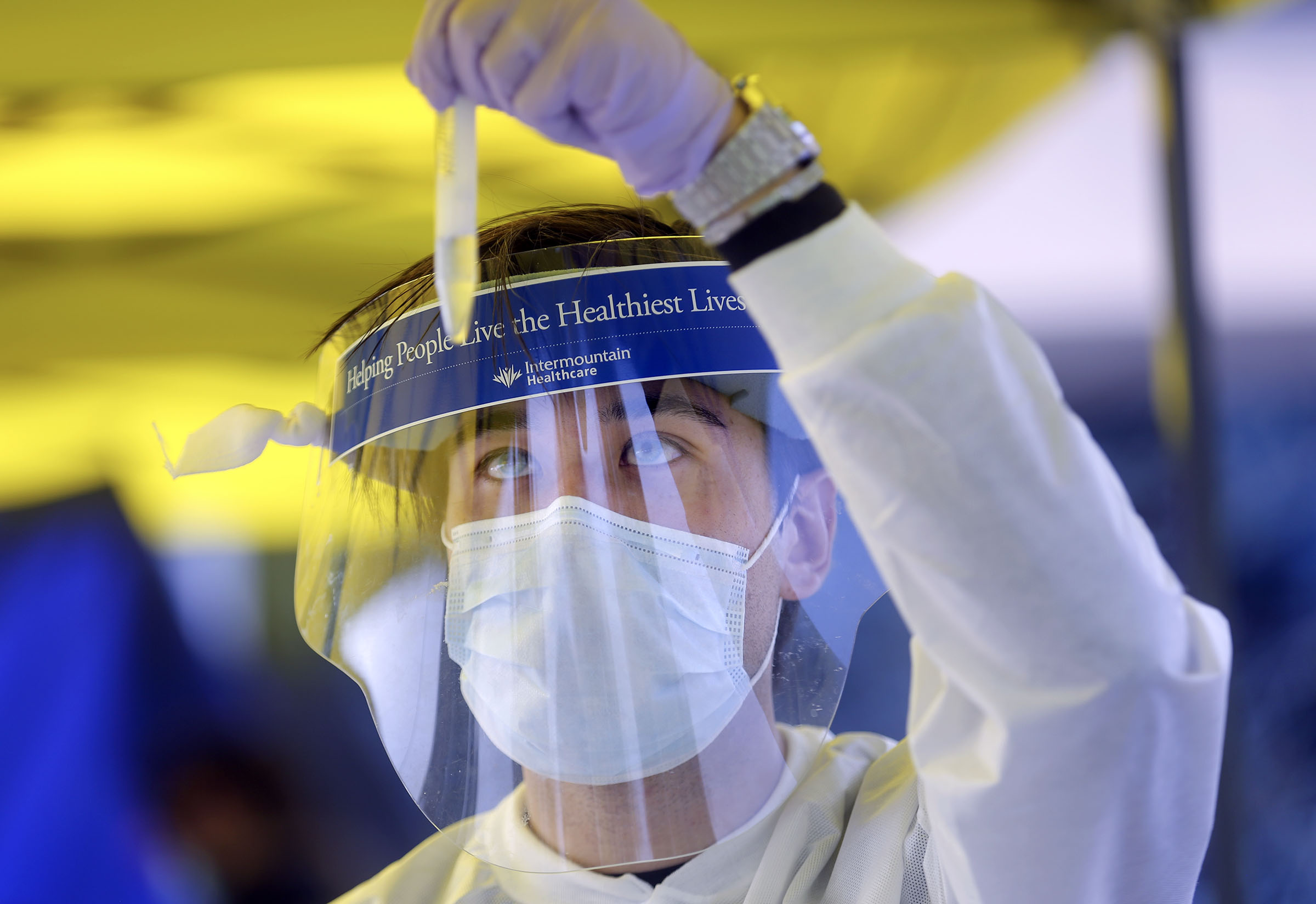 Phlebotomist David Sagae checks a vial of saliva at an Intermountain Healthcare COVID-19 mobile testing site outside of Orem Community Hospital in Orem on Tuesday, Oct. 6, 2020.