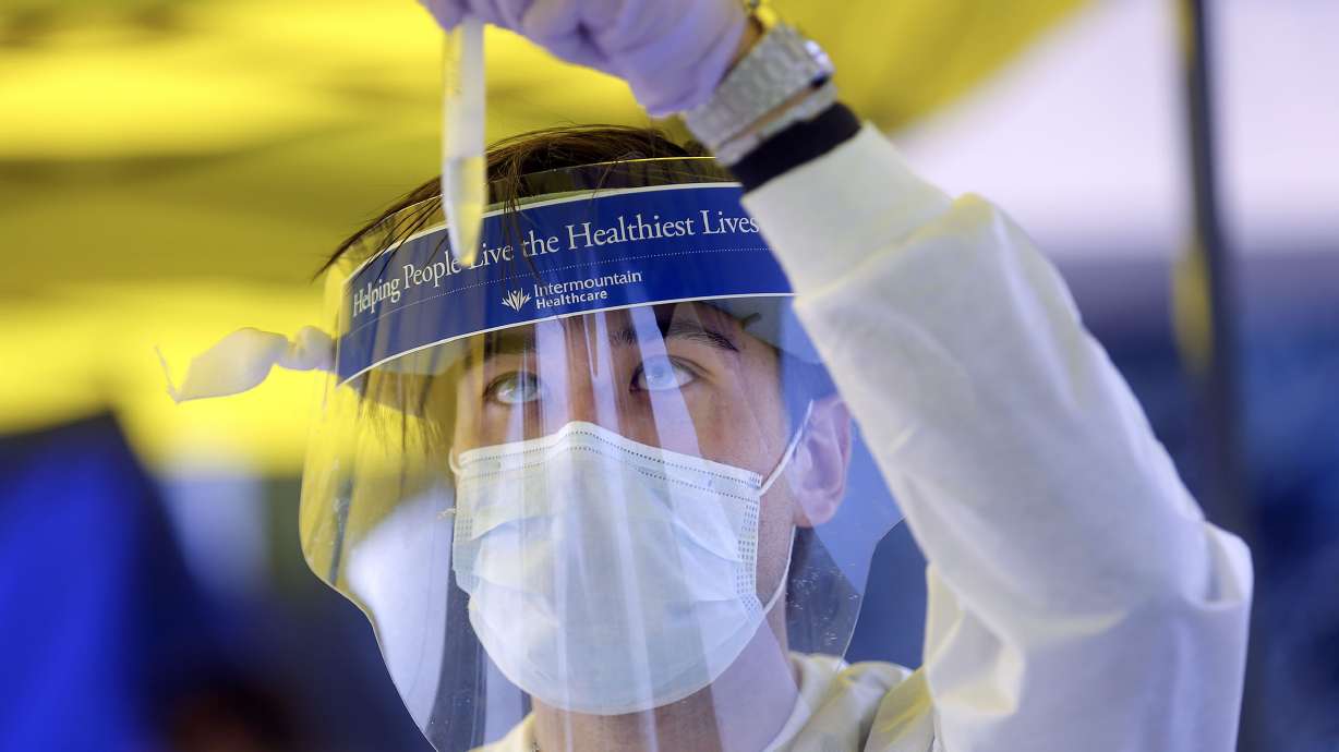 Phlebotomist David Sagae checks a vial of saliva at an Intermountain Healthcare COVID-19 mobile testing site outside of Orem Community Hospital in Orem on Tuesday, Oct. 6, 2020.