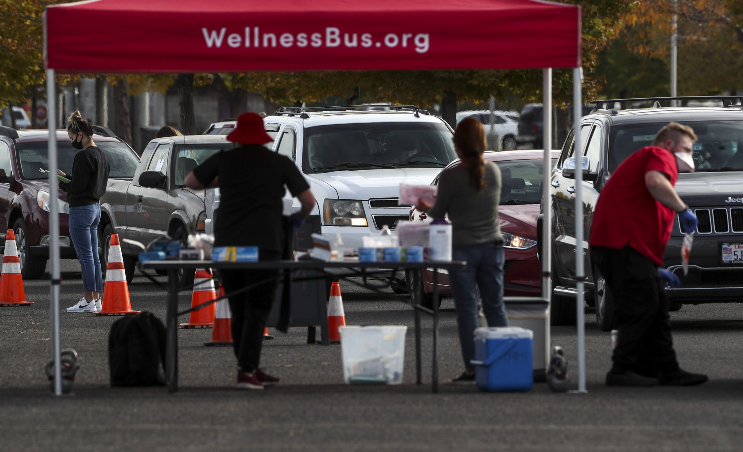 Vehicles form a line for COVID-19 testing as the University Health Wellness Bus visits Centennial Park in West Valley City on Monday, Oct. 19, 2020.