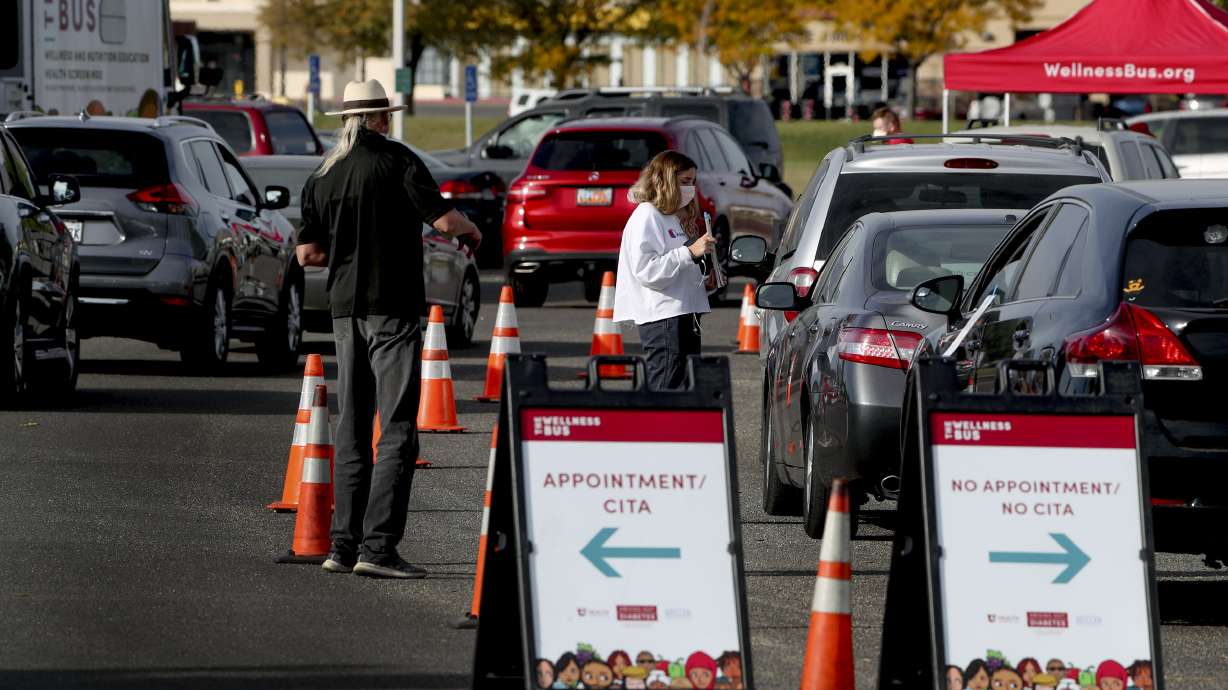 Vehicles form a line for COVID-19 testing as the University Health Wellness Bus visits Centennial Park in West Valley City on Monday, Oct. 19, 2020.