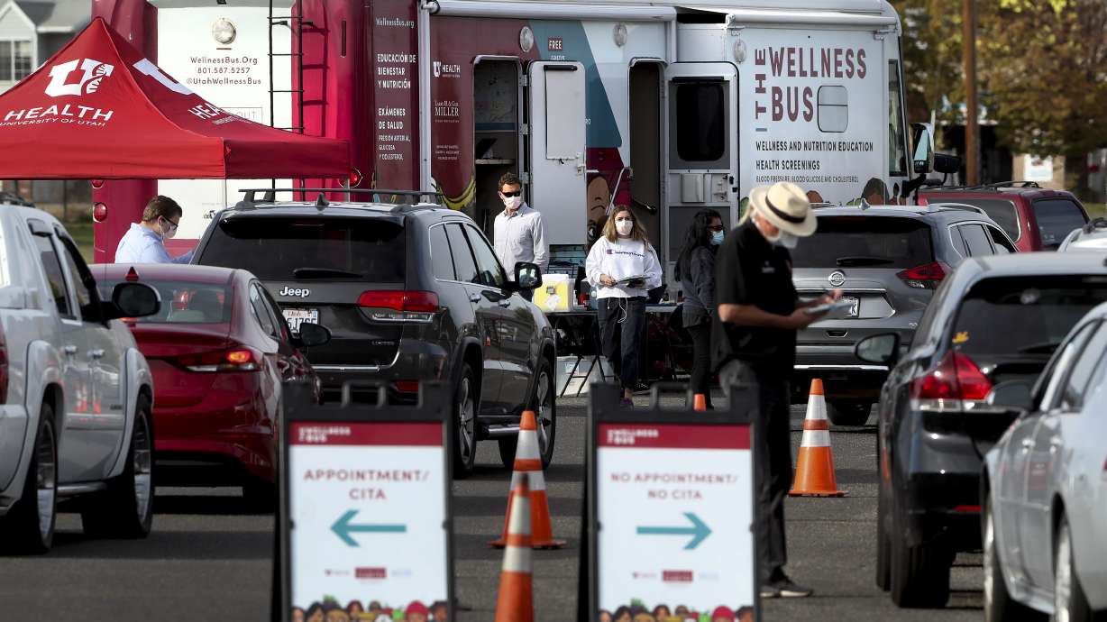 Vehicles form a line for COVID-19 testing as the University Health Wellness Bus visits Centennial Park in West Valley City on Monday, Oct. 19, 2020.