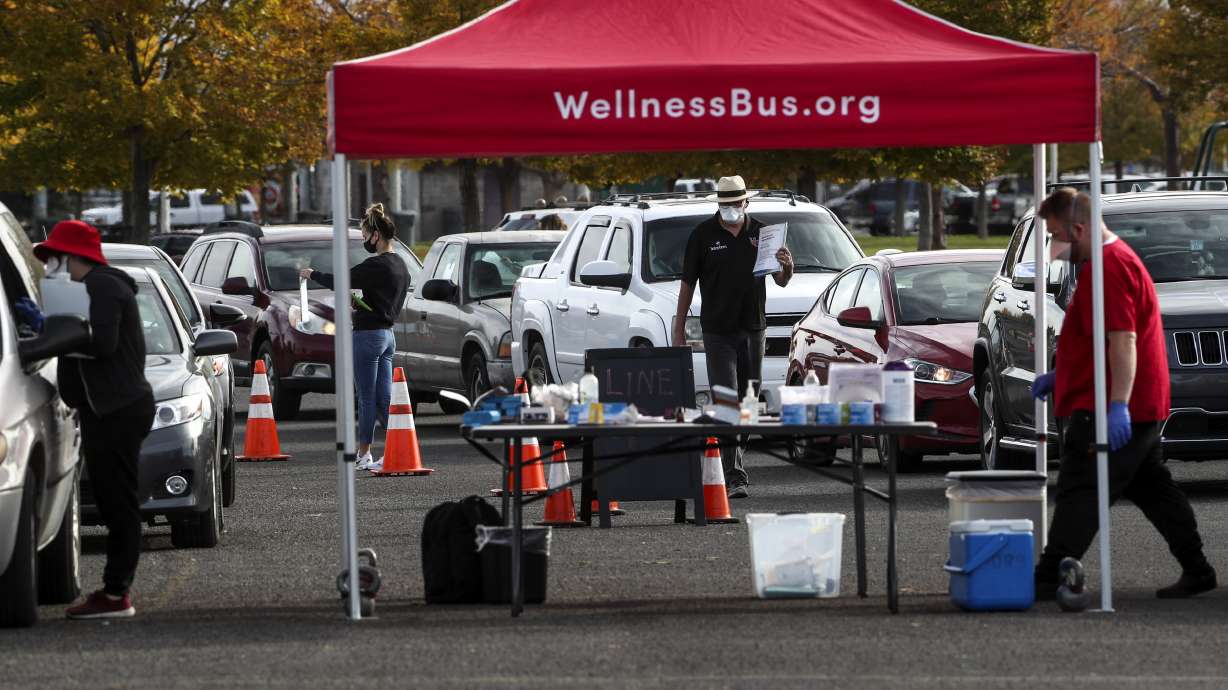 Vehicles form a line for COVID-19 testing as the University Health Wellness Bus visits Centennial Park in West Valley City on Monday, Oct. 19, 2020.