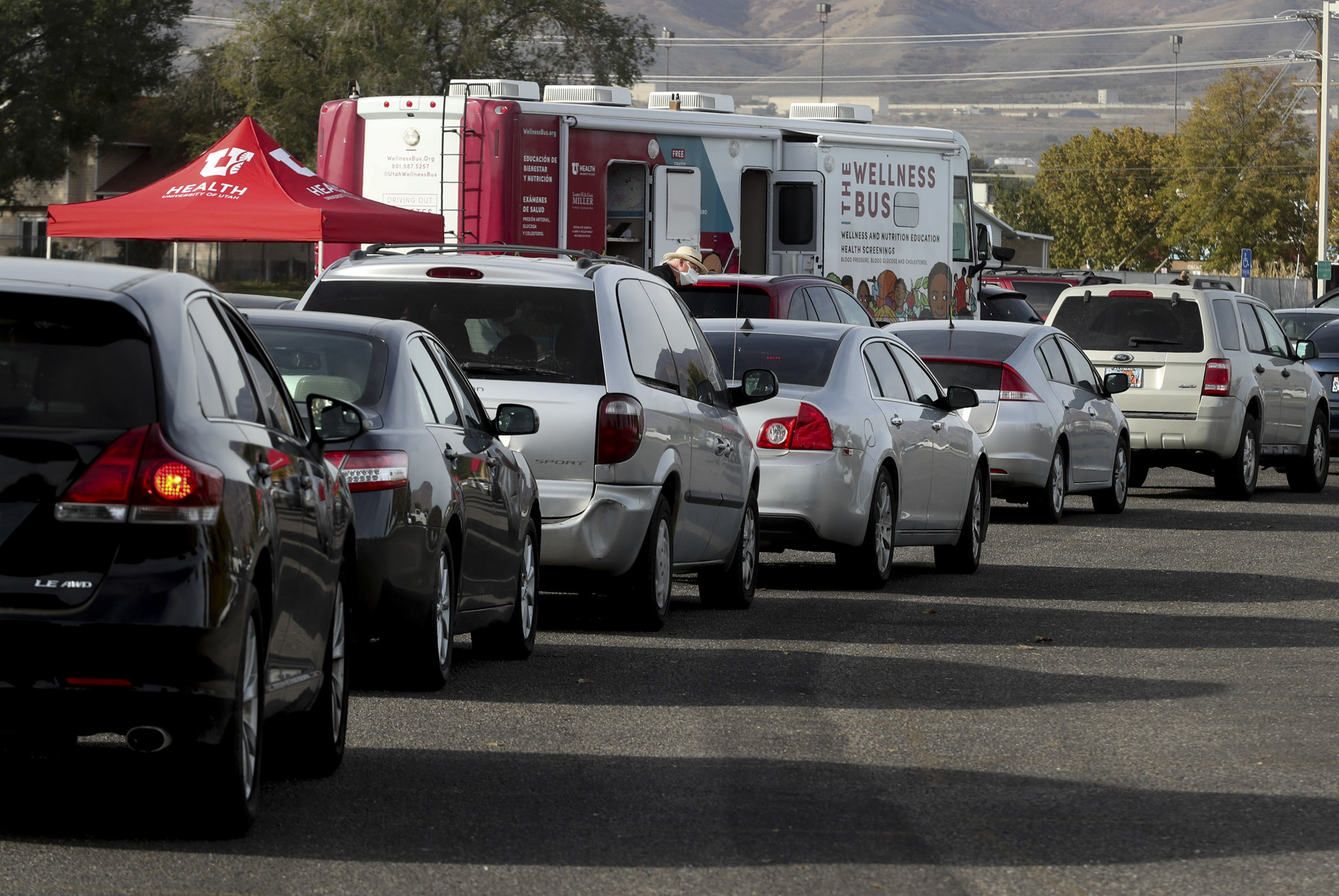 Vehicles form a line for COVID-19 testing as the University Health Wellness Bus visits Centennial Park in West Valley City on Monday, Oct. 19, 2020.