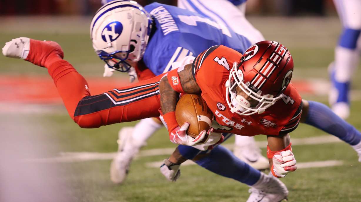 BYU and Utah in the nearly annual rivalry matchup.
Utah Utes running back TJ Green (4) dives forward as BYU and Utah play at Rice Eccles Stadium in Salt Lake City on Saturday, Nov. 24, 2018.