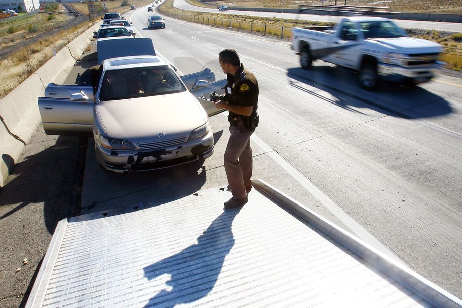 Utah Highway Patrol Troopers search a car after conducting a road side sobriety test in 2012. 