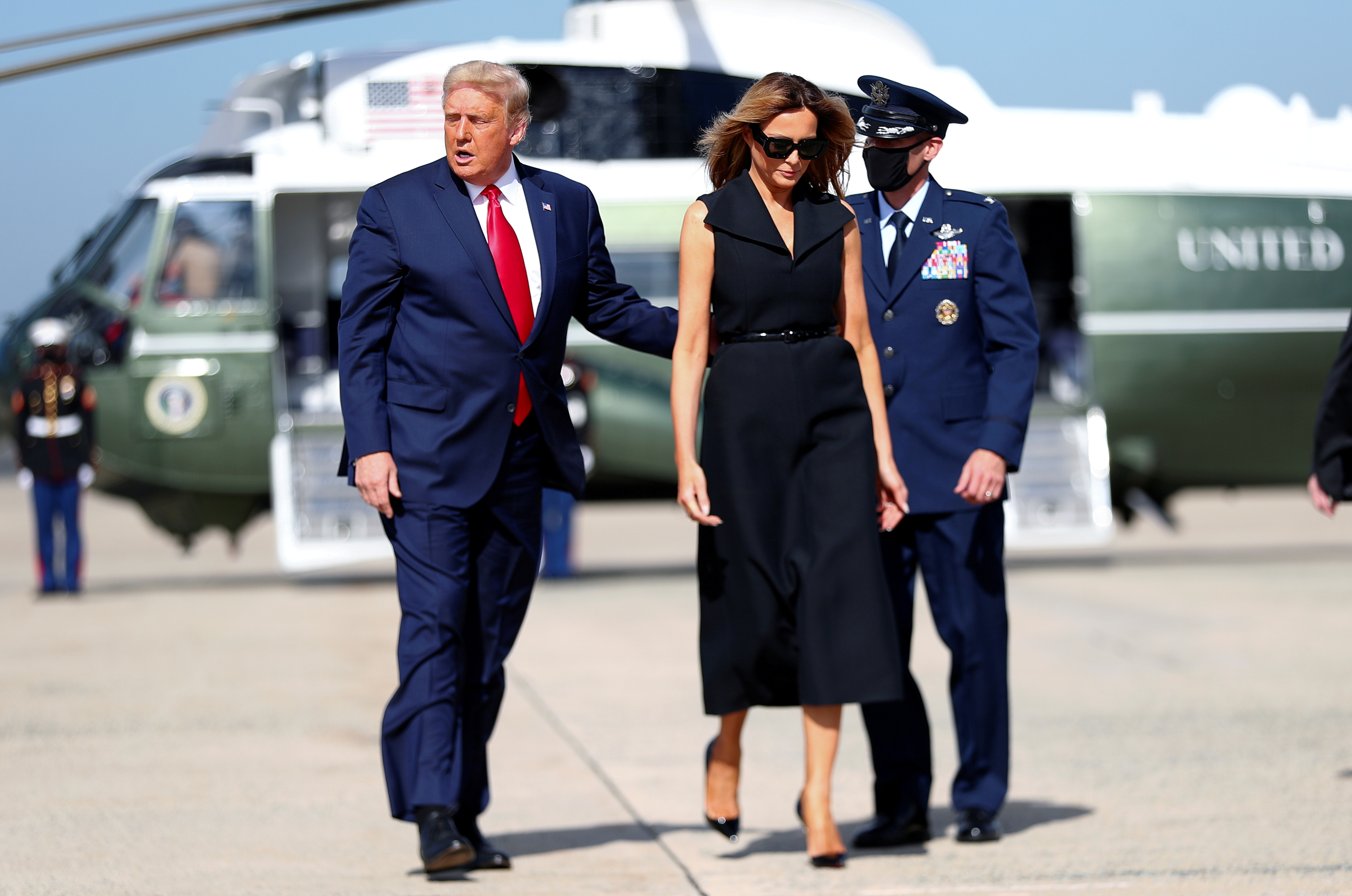 U.S. President Donald Trump walks from Marine One with first lady Melania Trump to board Air Force One as they depart Washington on campaign travel to Nashville, Tennessee to attend his second and final debate with Democratic presidential nominee Joe Biden, at Joint Base Andrews, Maryland, U.S., Oct. 22, 2020. REUTERS/Tom Brenner
