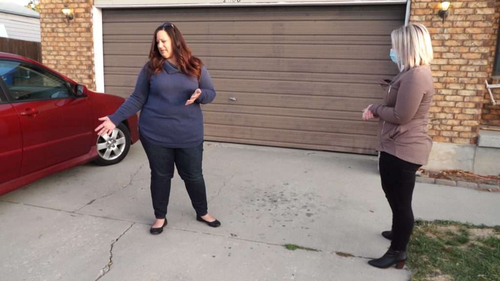 Stephanie Barrick pointing to where the criminals allegedly left a gun in her driveway leaving the scene.