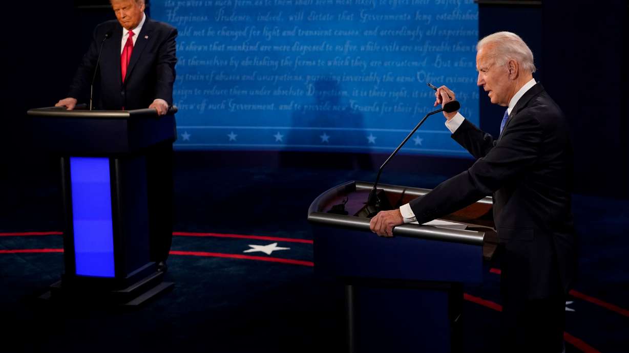 Democratic presidential candidate former Vice President Joe Biden answers a question and U.S. President Donald Trump listens during the second and final presidential debate at the Curb Event Center at Belmont University in Nashville, Tennessee, U.S., October 22, 2020. Morry Gash/Pool via REUTERS