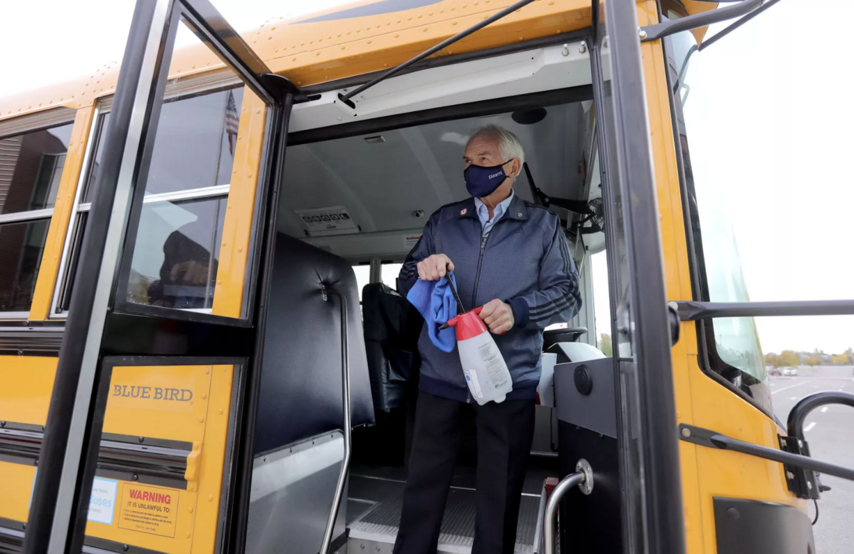 Neal Hendrickson, a former state legislator and current school bus driver, demonstrates how he sanitizes a school bus to prevent the spread of COVID-19 during a press conference about school bus safety outside of Granger High School in West Valley City on Friday, Oct. 23, 2020.