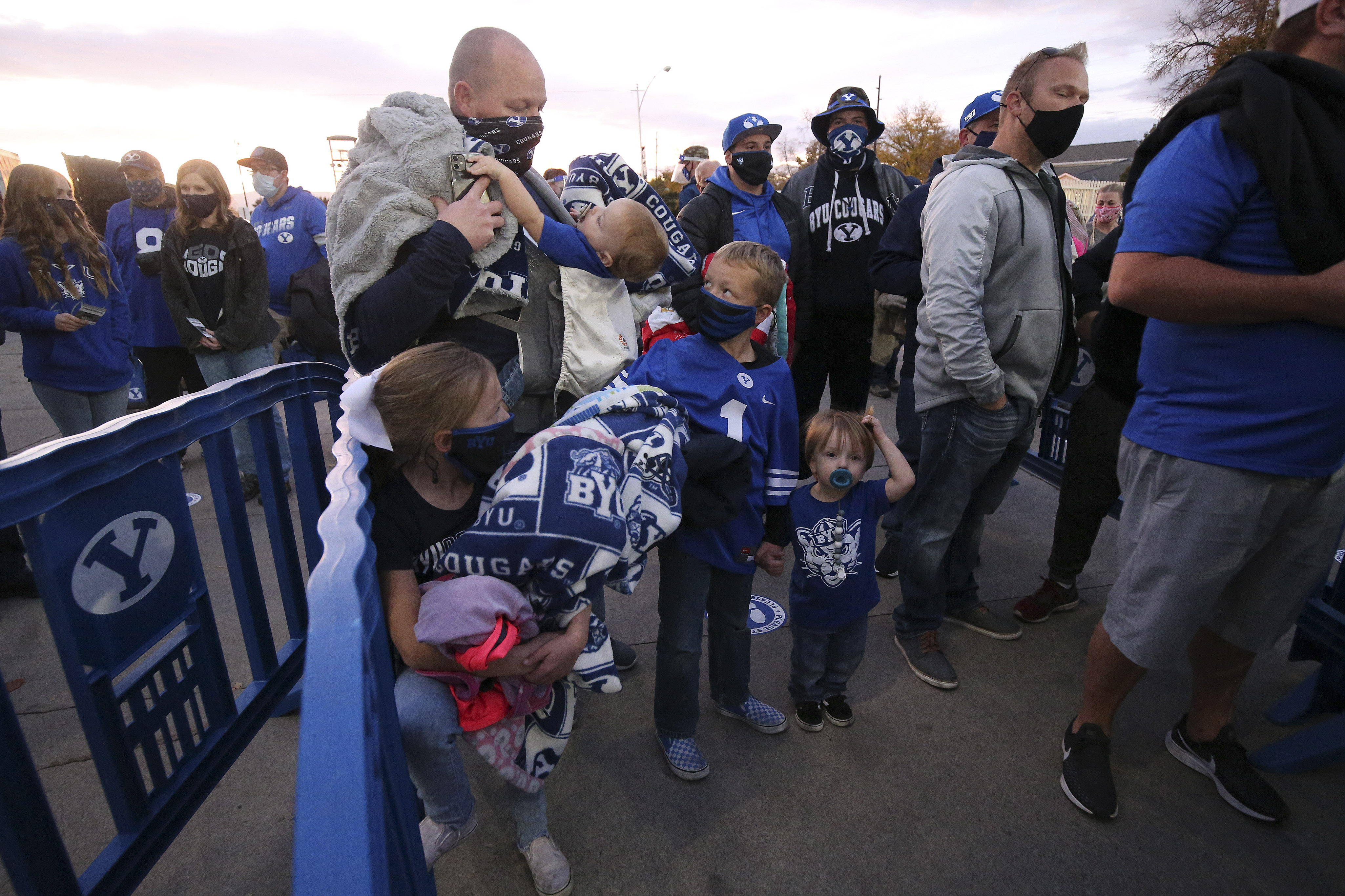 Brett Braegger and his children Hudson, Paityn, Boston and Kamden wait to enter LaVell Edwards Stadium in Provo on Saturday, Oct. 24, 2020.